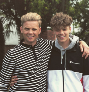 Dad and son smiling at the camera