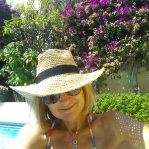 Carol McGiffin poses in a straw hat while on holiday in Spain 