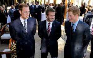 Prince William speaks to David Beckham (C) and Prince Harry (R) at an FA reception at the Saxon Hotel on June 19, 2010