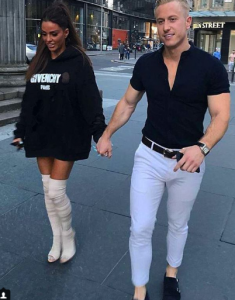 Katie Price steps out in white over the knee boots as she holds hands with boyfriend Kris Boyson 