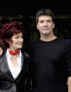 Sharon Osbourne and Simon Cowell pose for photos after auditioning hundreds of hopeful musicians for their new TV show 'X Factor' on Julr6, 2004