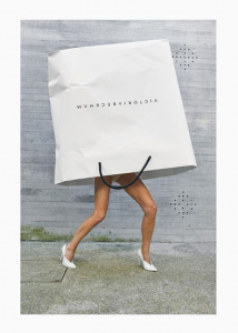 Victoria Beckham poses with an own-brand carrier bag over her head