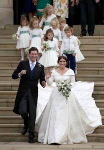 Jack Brooksbank and Princess Eugenie of York walk down the steps followed by their page boys and bridesmaids after their wedding ceremony at St. George's Chapel on October 12, 2018 in Windsor, England. (Photo by Andrew Matthews - WPA Pool/Getty Images)