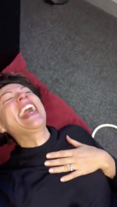 Kate Silverton laughing on floor, laughing gas