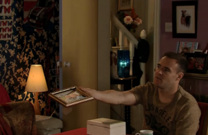 Tyrone shows Evelyn a photo of Vera