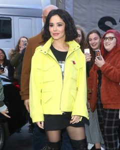 Cheryl seen arriving at capital radio in London wearing a yellow jacket to promote new single "Love Made Me Do It"