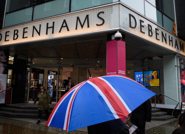 Shoppers pass a branch of the Debenhams chain of department stores on Oxford Street