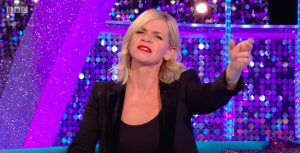 Zoe sits on the It Takes Two sofa