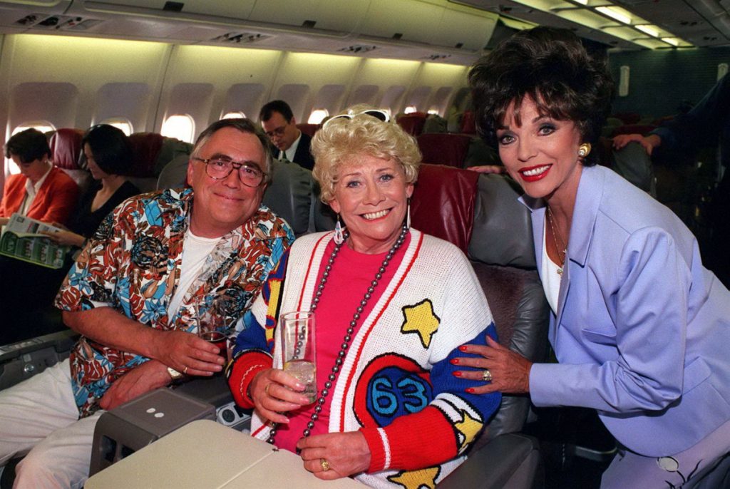 ITV ARCHIVE 'Coronation Street' TV - 1997 - Las Vegas - Jac and Vera Duckworth [Bill Tarmey, Liz Dawn] on plane with Joan Collins 1997 Image ID: 852820nq Featured in: ITV ARCHIVE Photo Credit: ITV/Shutterstock