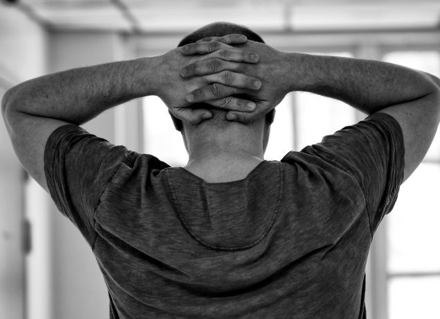 Black and white guy hands behind head