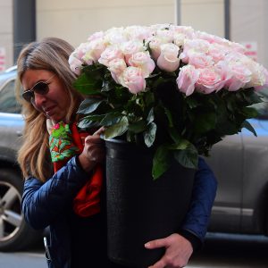 A woman carries decorations