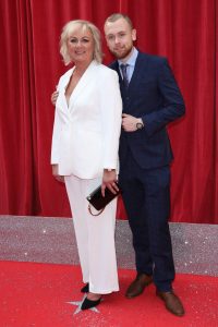 34334593 Headline : The British Soap Awards 2018 Caption : The British Soap Awards 2018 held at the Hackney Empire - Arrivals PersonInImage : Sue Cleaver,Elliot Quinn Credit : Lia Toby/WENN.com