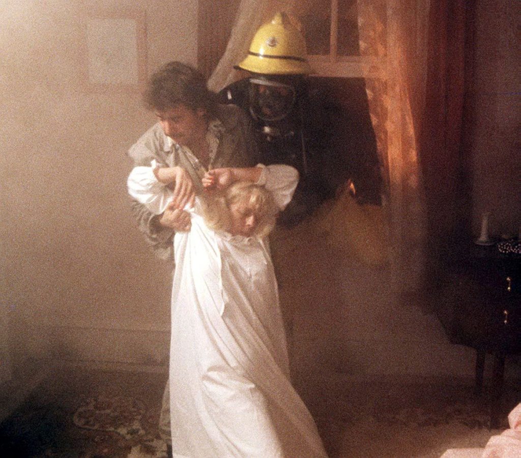 Editorial use only. Exclusive - Premium Rates Apply. Call your Account Manager for pricing. Mandatory Credit: Photo by ITV/REX/Shutterstock (669486bs) Rovers Return Fire 'Coronation Street' TV - 1986 Julie Goodyear and Michael Le Vell (centre) ITV ARCHIVE