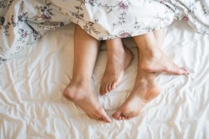 Adults feet in bed