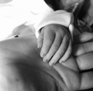 Kym holds her grandson's hand