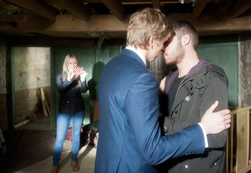 Editorial use only Mandatory Credit: Photo by ITV/REX/Shutterstock (8965291gr) Ep 7098 Thursday 5 February 2015 - 1st Ep A suited Robert Sugden, as played by Ryan Hawley, arrives and Aaron Livesy, as played by Danny Miller, implores him to call off the wedding, telling him he loves him. Robert refuses. As Robert makes to leave, Aaron hastily texts Katie 'Wylie's Farm, now? Aaron goes after Robert and it's not long before they are embroiled in a passionate kiss. But when the sound of a camera phone taking a shot cuts through the air, a panicked Robert pulls away. Katie Sugden, as played by Sammy Winward, finally has the evidence she needs... 'Emmerdale' TV Series - Jan 2015