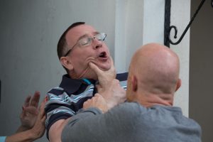 WARNING: Embargoed for publication until 00:00:01 on 24/07/2019 - Programme Name: EastEnders - July - September - 2019 - TX: 23/07/2019 - Episode: EastEnders - July - September - 2019 - 5959 (No. 5959) - Picture Shows: *NOT FOR USE PRE-TX WITHOUT PRIOR APPROVAL* Ian grabs Max by the throat. Ian Beale (ADAM WOODYATT), Max Branning (JAKE WOOD) - (C) BBC - Photographer: Jack Barnes