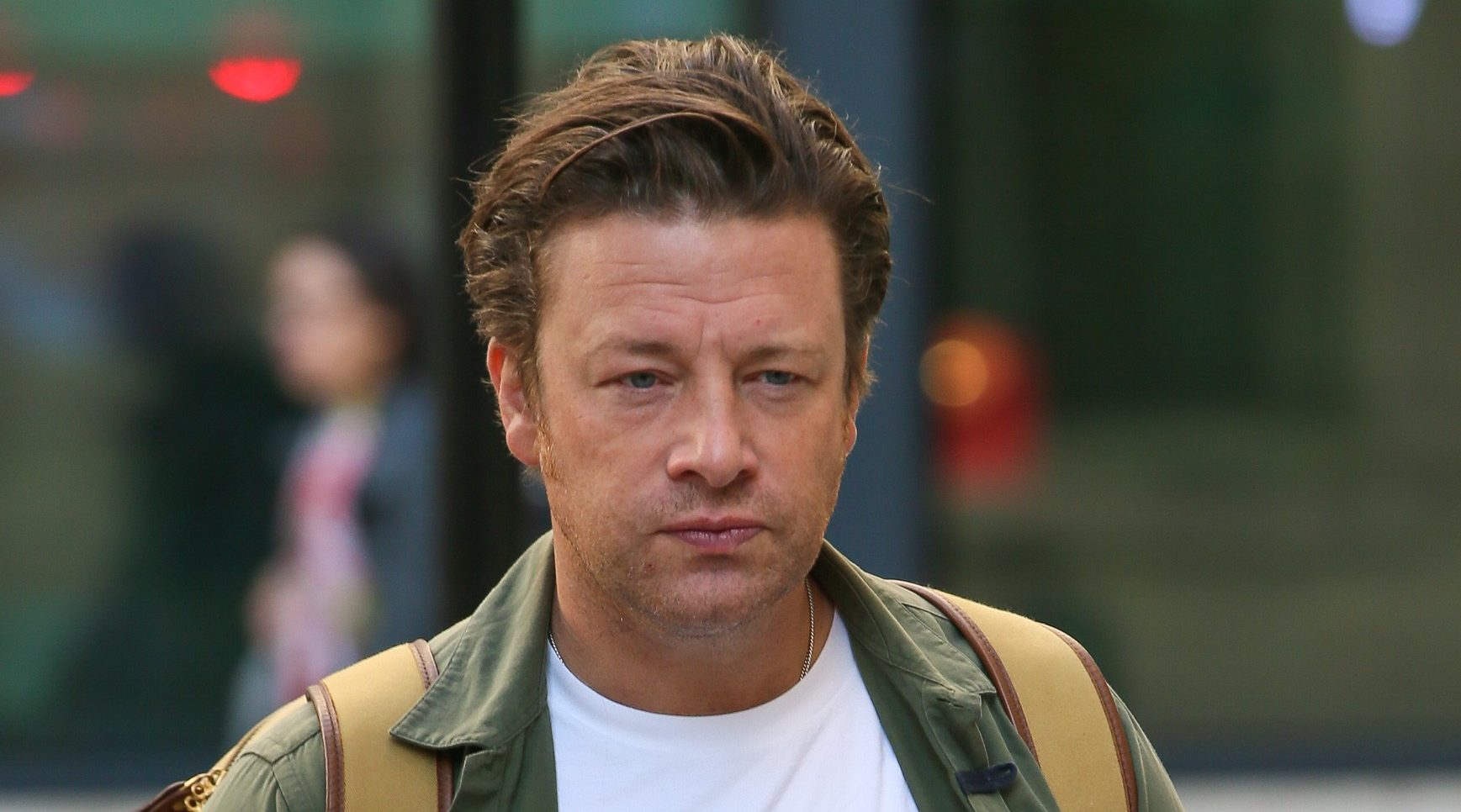 Jamie Oliver avoids the camera as he walks down the street