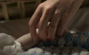 A mother holding her baby's hand in Call The Midwife