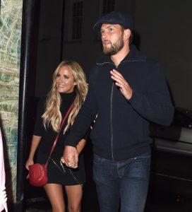 Caroline Flack and Lewis Burton on a night out before the assault charge (Credit: Splash News)