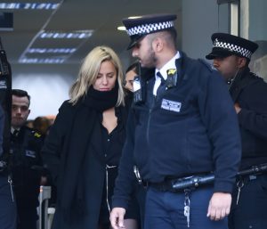 Caroline Flack attends court in December, flanked by police (Credit: Splash News)