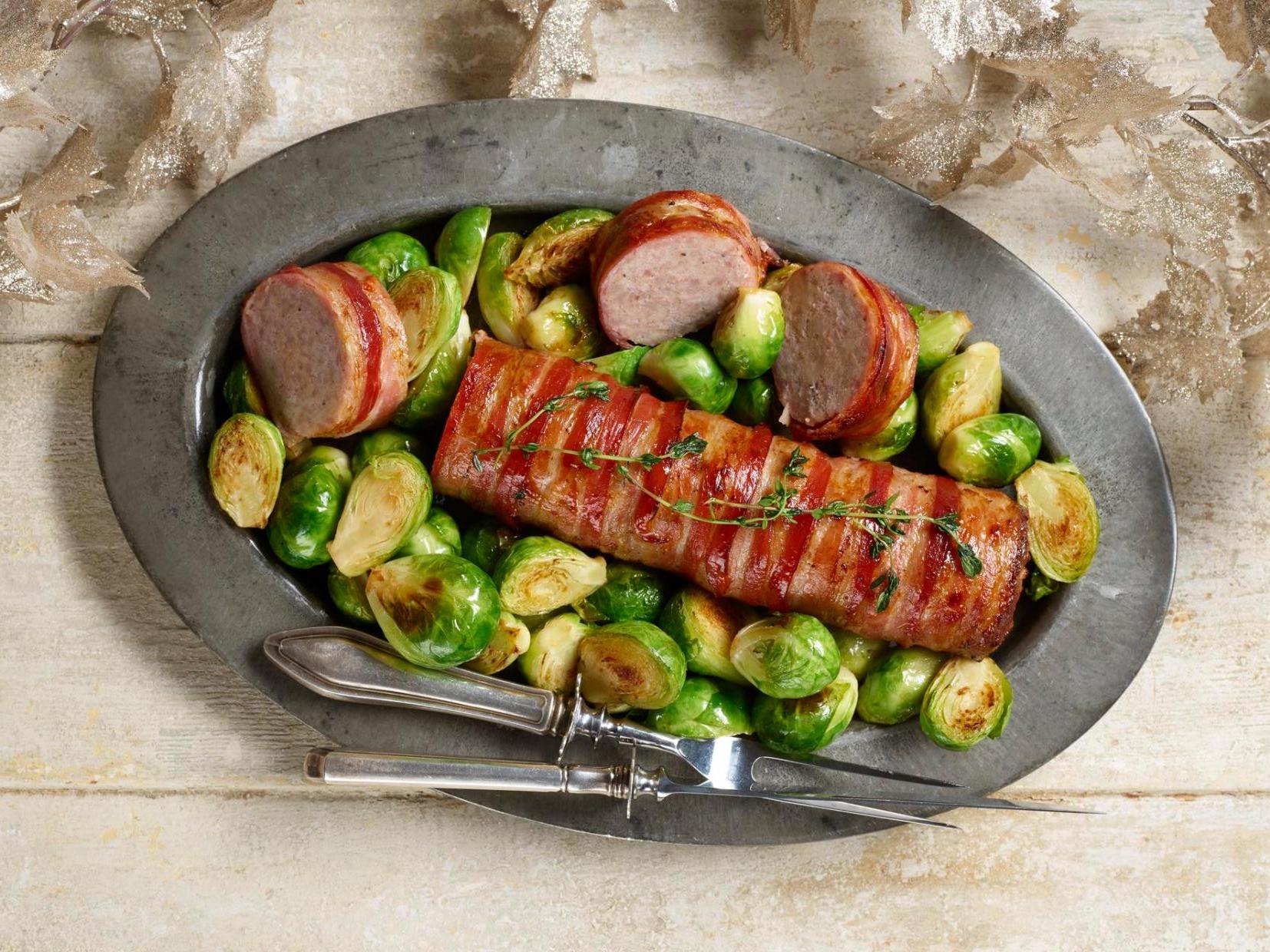 Styled picture of a giant pig in blanket with some Brussels sprouts