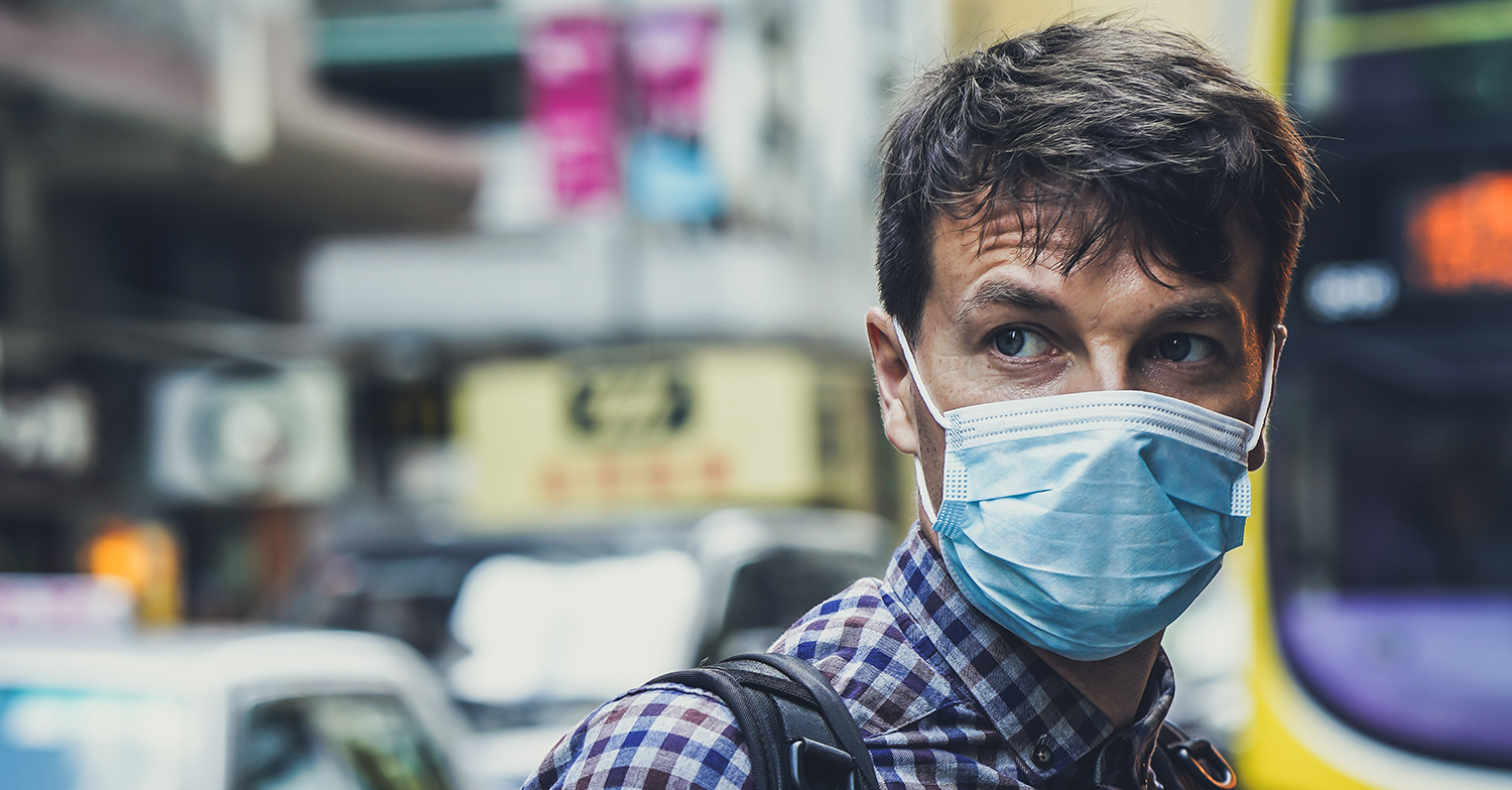man wearing a face mask in the city