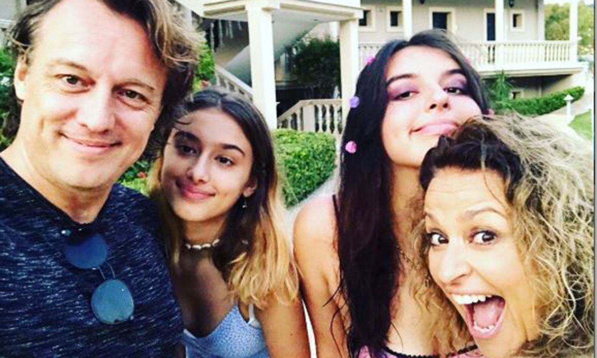 Nadia Sawalha and her husband and two kids smiling