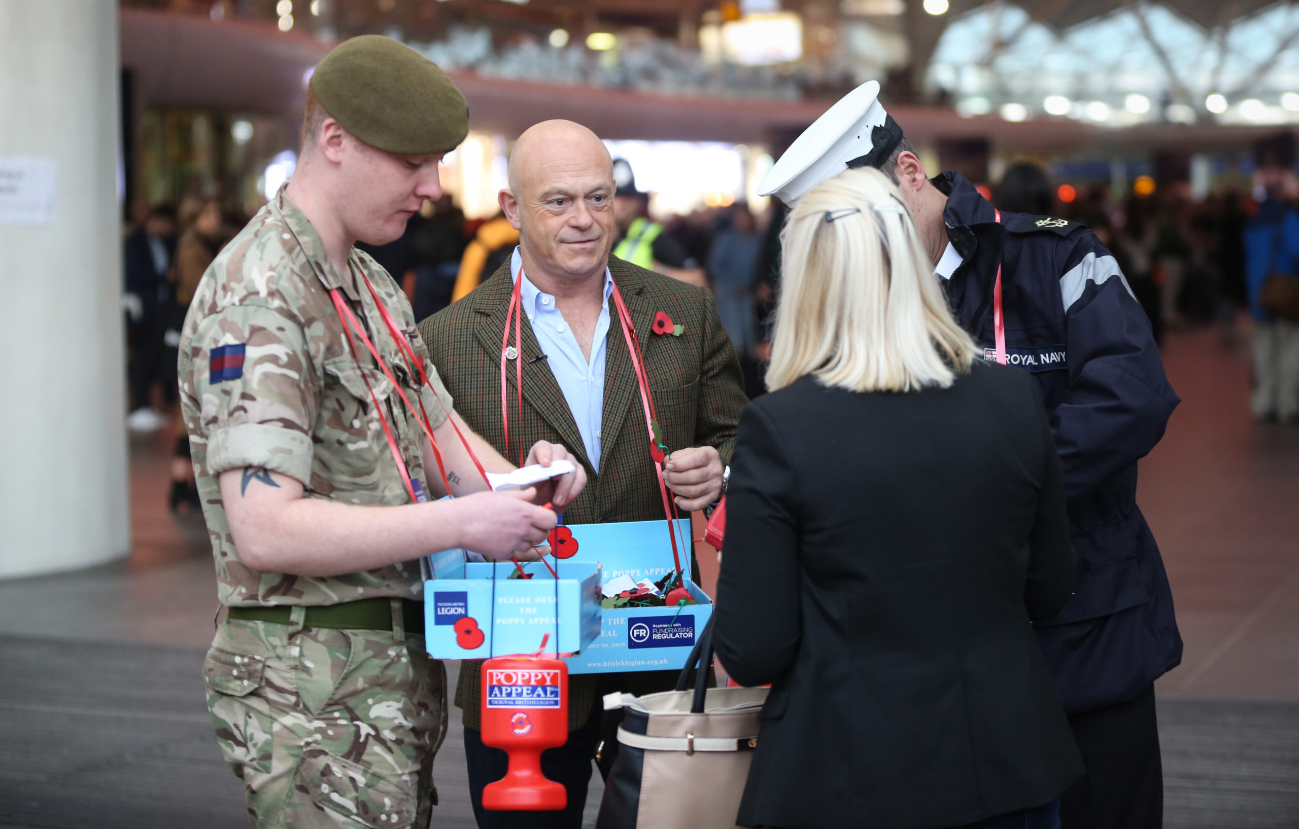 Ross Kemp giving out poppies with soldiers