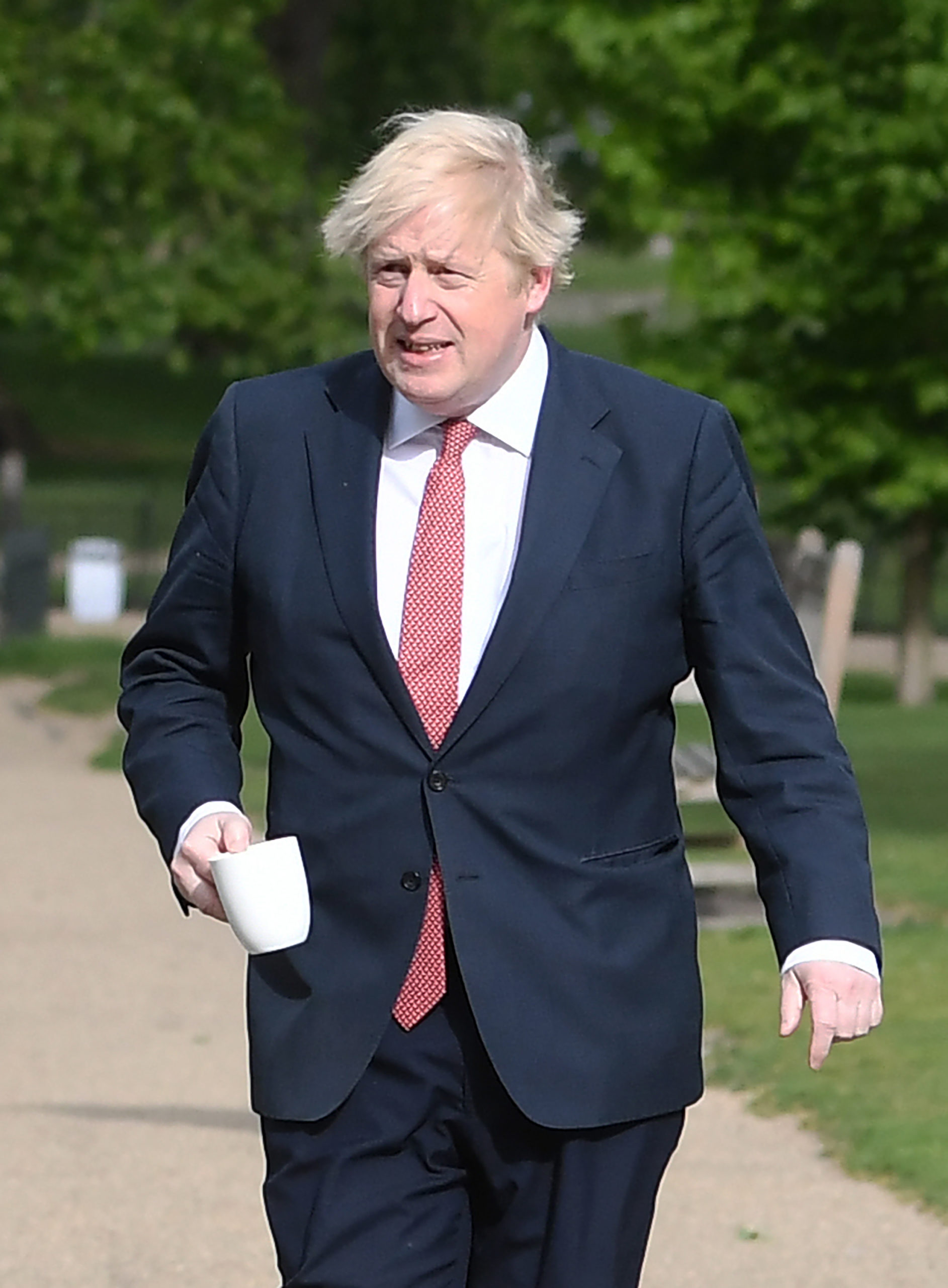 Boris Johnson with a cup of coffee in the park