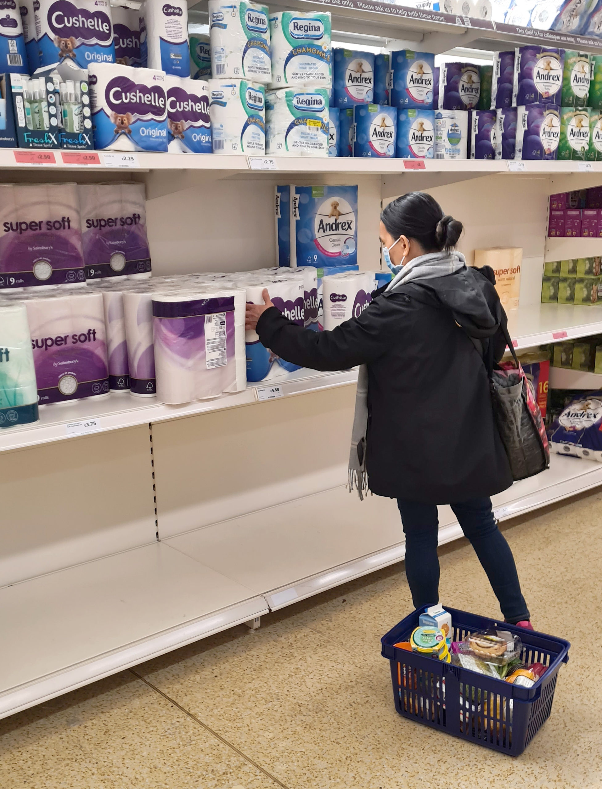 A woman shopping for toilet roll in Sainsbury's