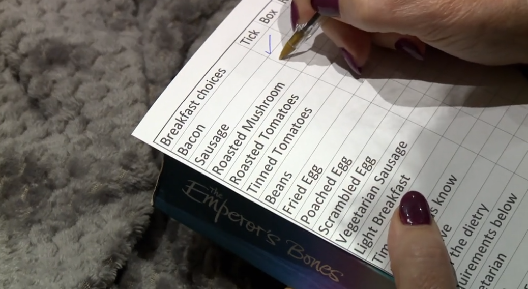 A contestant filling out a pre-order sheet on Four in a Bed
