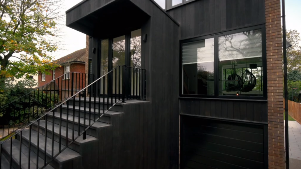 The house's black cladding on Ugly House to Lovely House