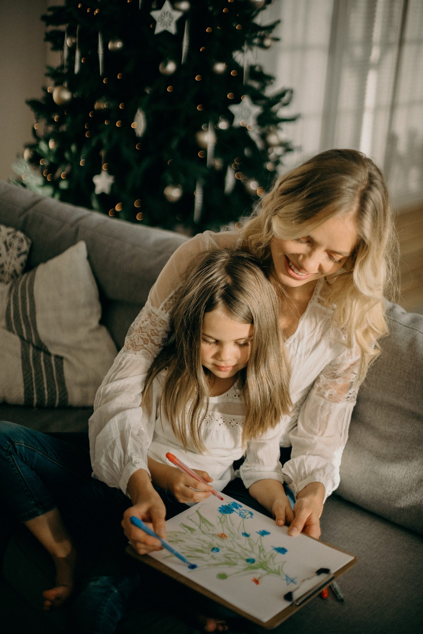 mother and daughter doing a Christmas colouring together