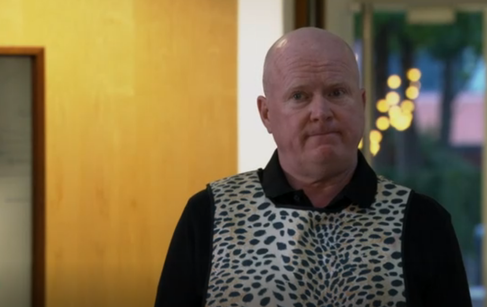 Phil in a leopard print apron in EastEnders