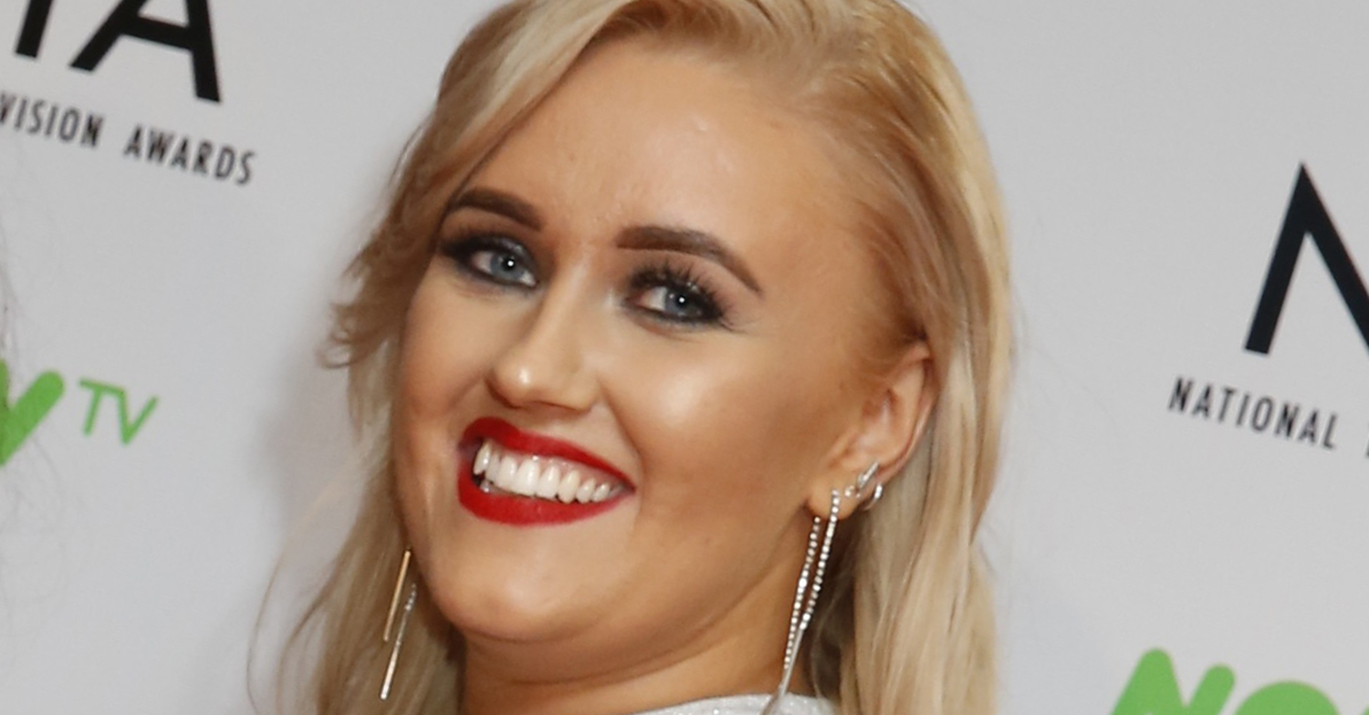 Ellie Warner smiling on the red carpet at the NTAs