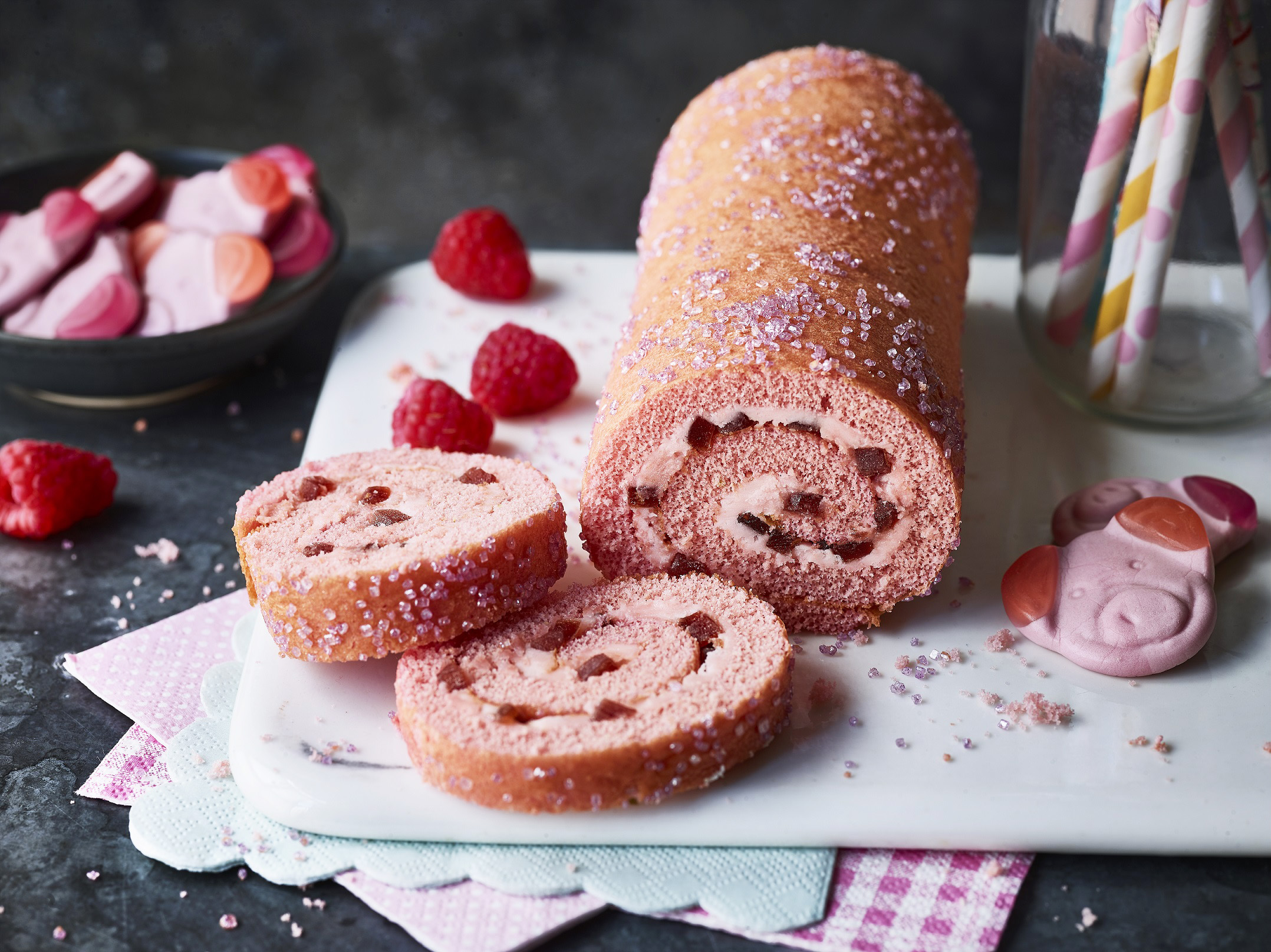 Percy Pig Swiss roll cut on a chopping board