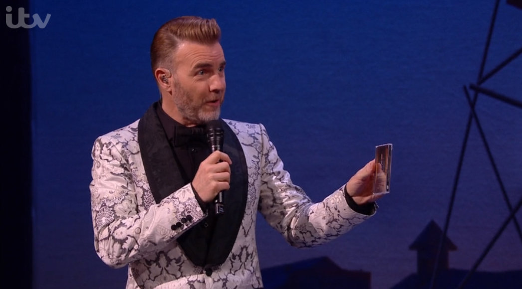 Gary Barlow holding the Jason Manford album A Different Stage