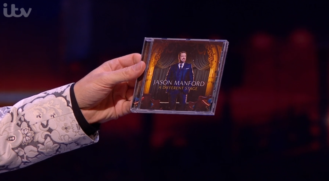 Gary Barlow holding the Jason Manford album A Different Stage