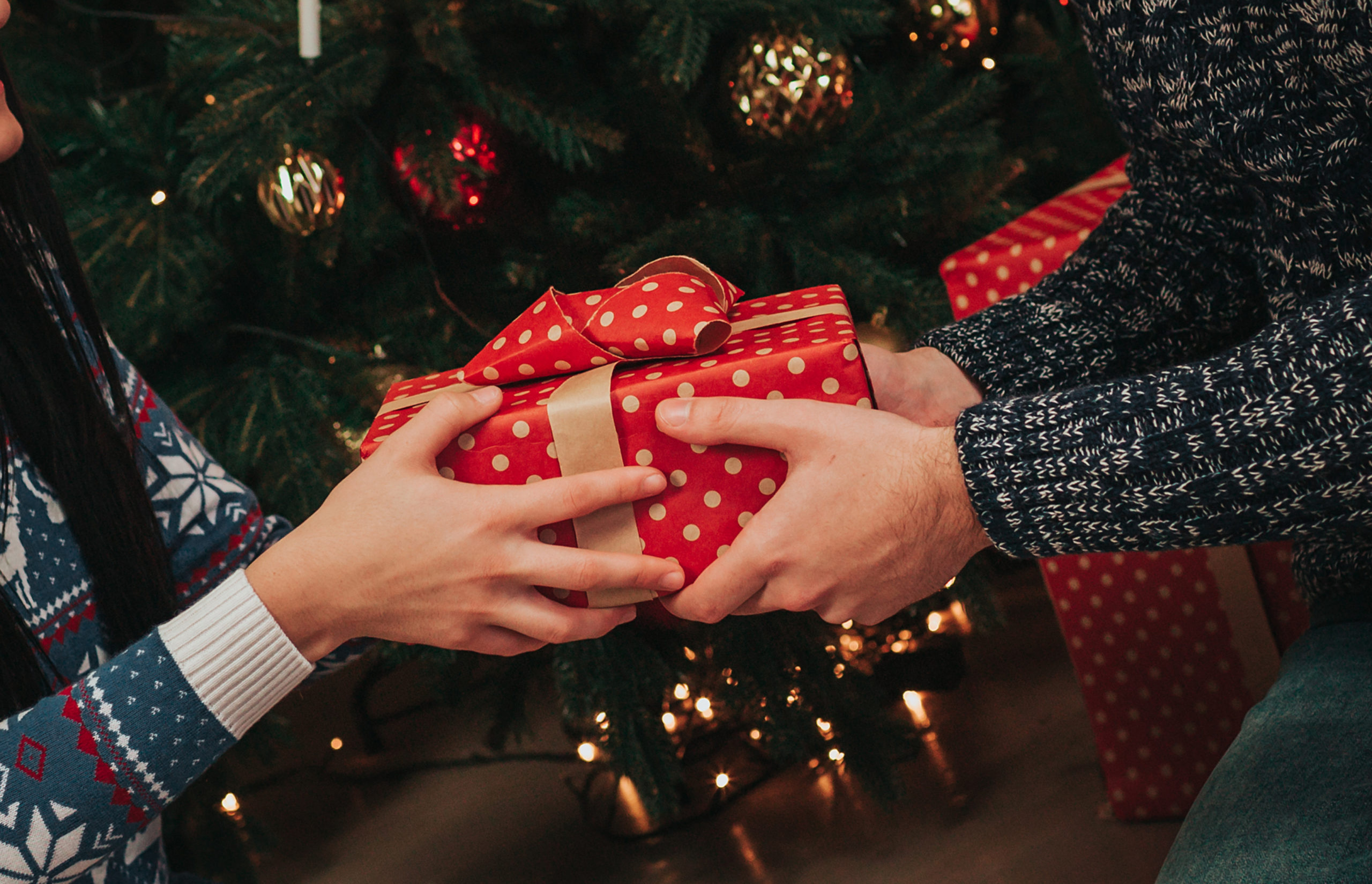 person giving a christmas present