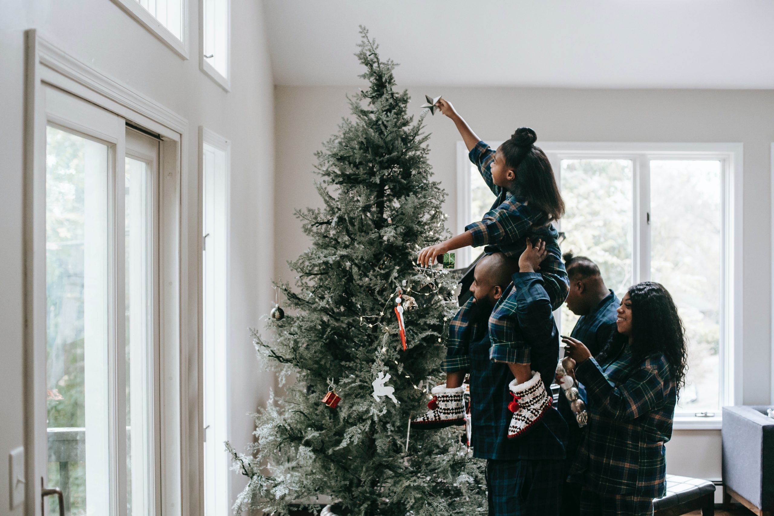 family decorating a christmas tree
