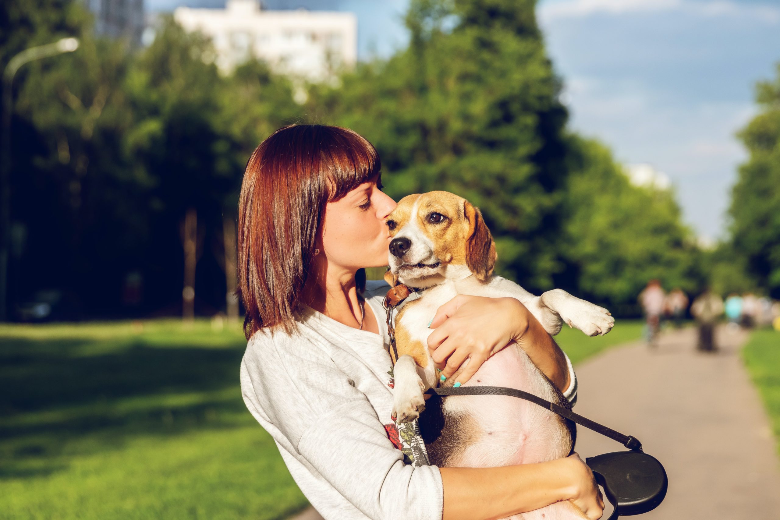 woman kissing a puppy