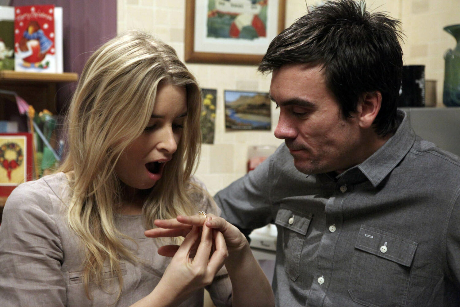 Charity looks shocked as she puts Cain's engagement ring on her finger