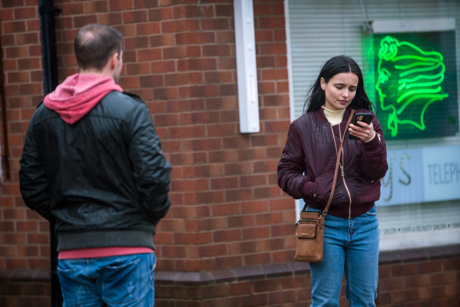 Alina Pop looking at her phone and Tyrone Coronation Street