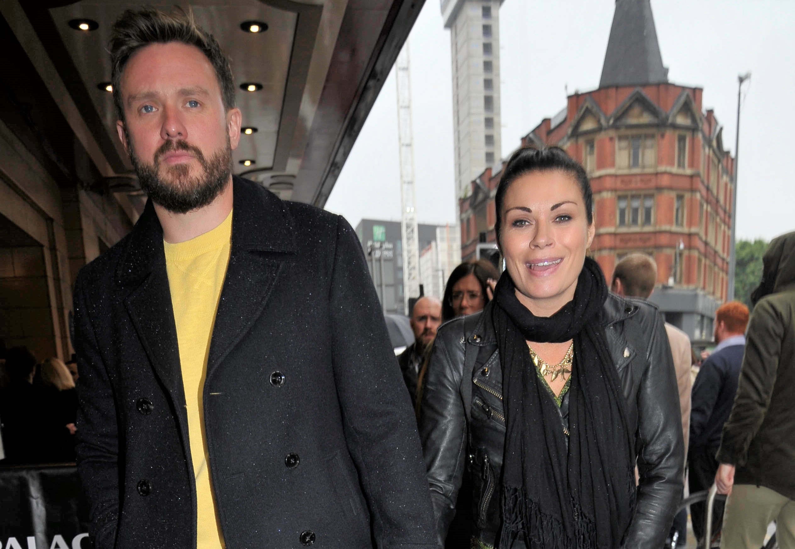 David Stuckley and Alison King smile as they arrive hand in hand at the Book Of Mormon press night