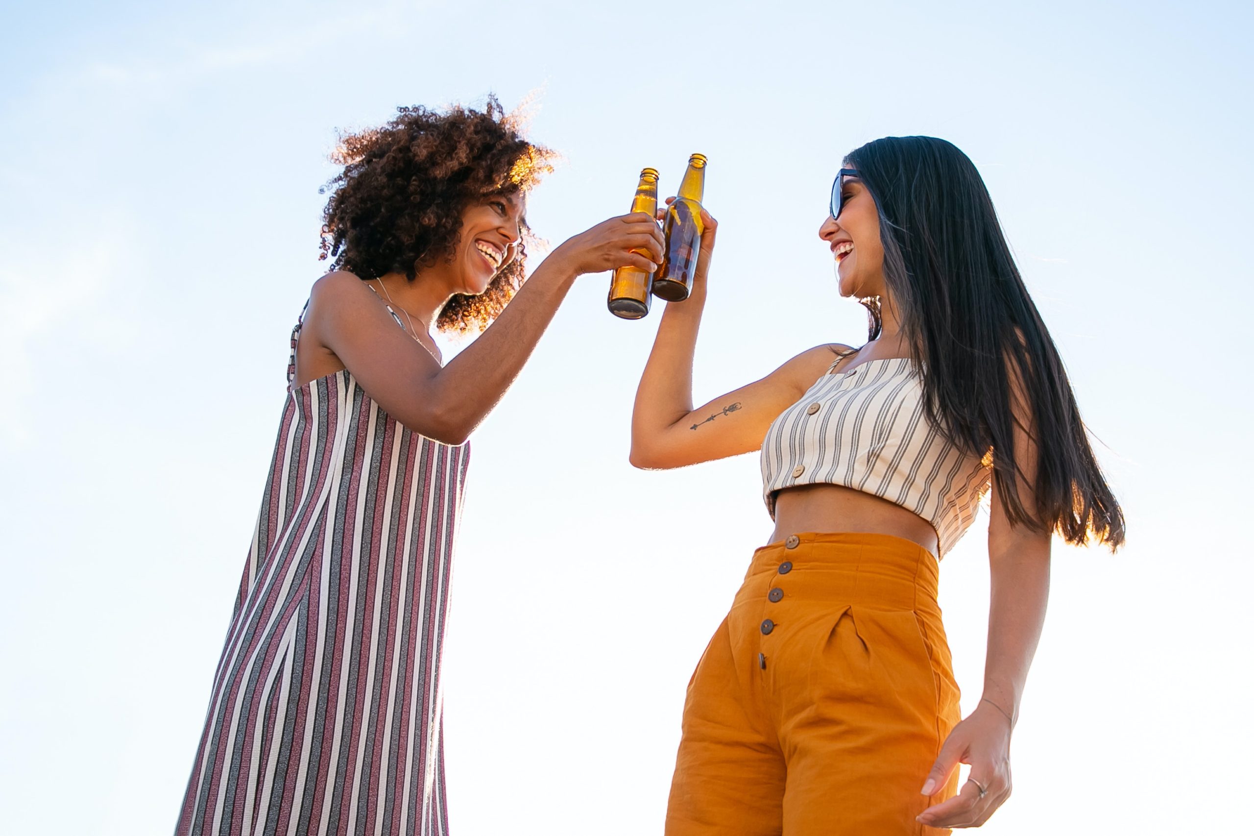 two women drinking. uk weather to pick up