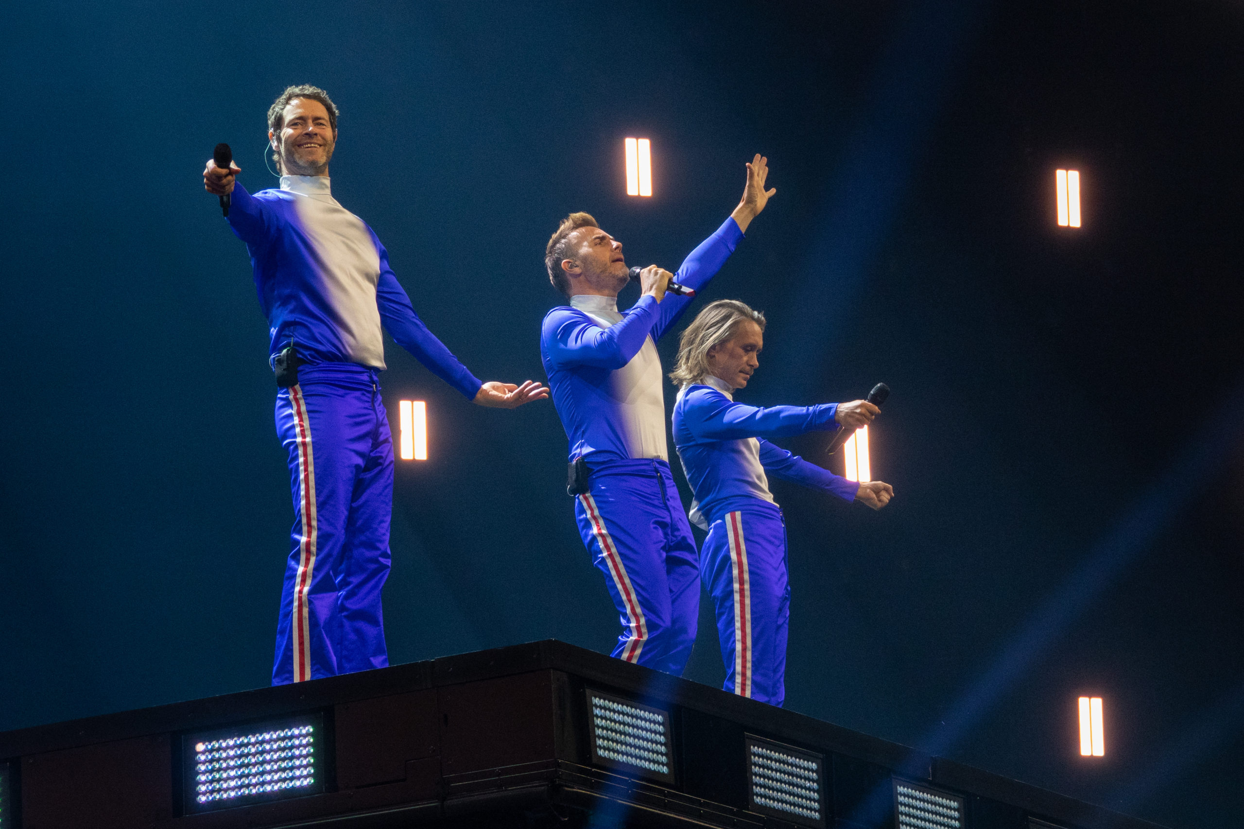 Take That performing, including Howard Donald, Gary Barlow and Mark Owen 