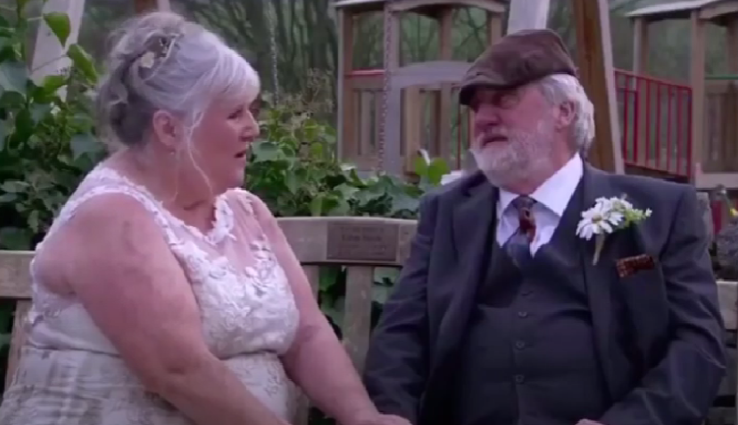 Lisa and Zak Dingle smiling at each other on their wedding day