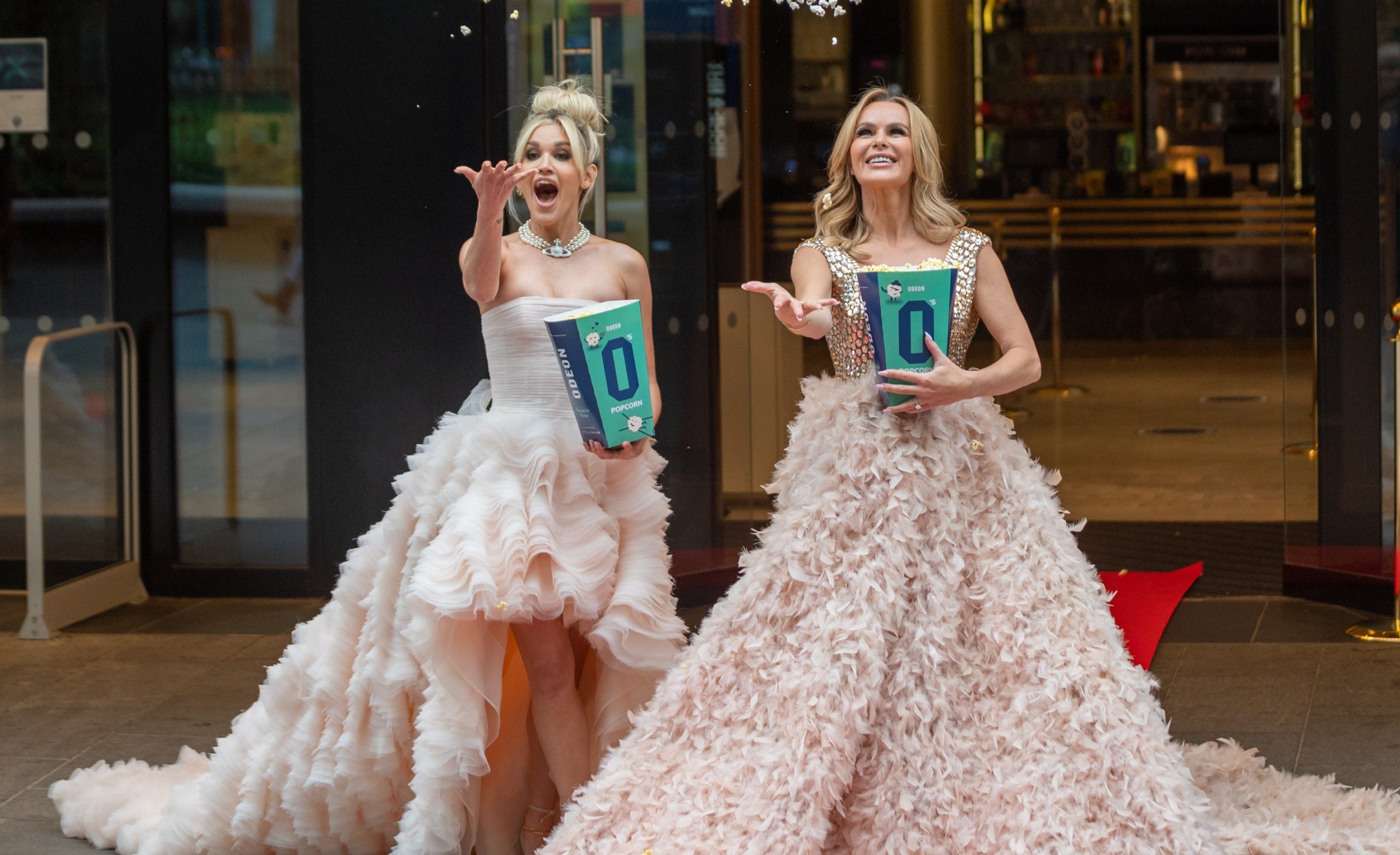 Amanda Holden and Ashley roberts throw popcorn in the air