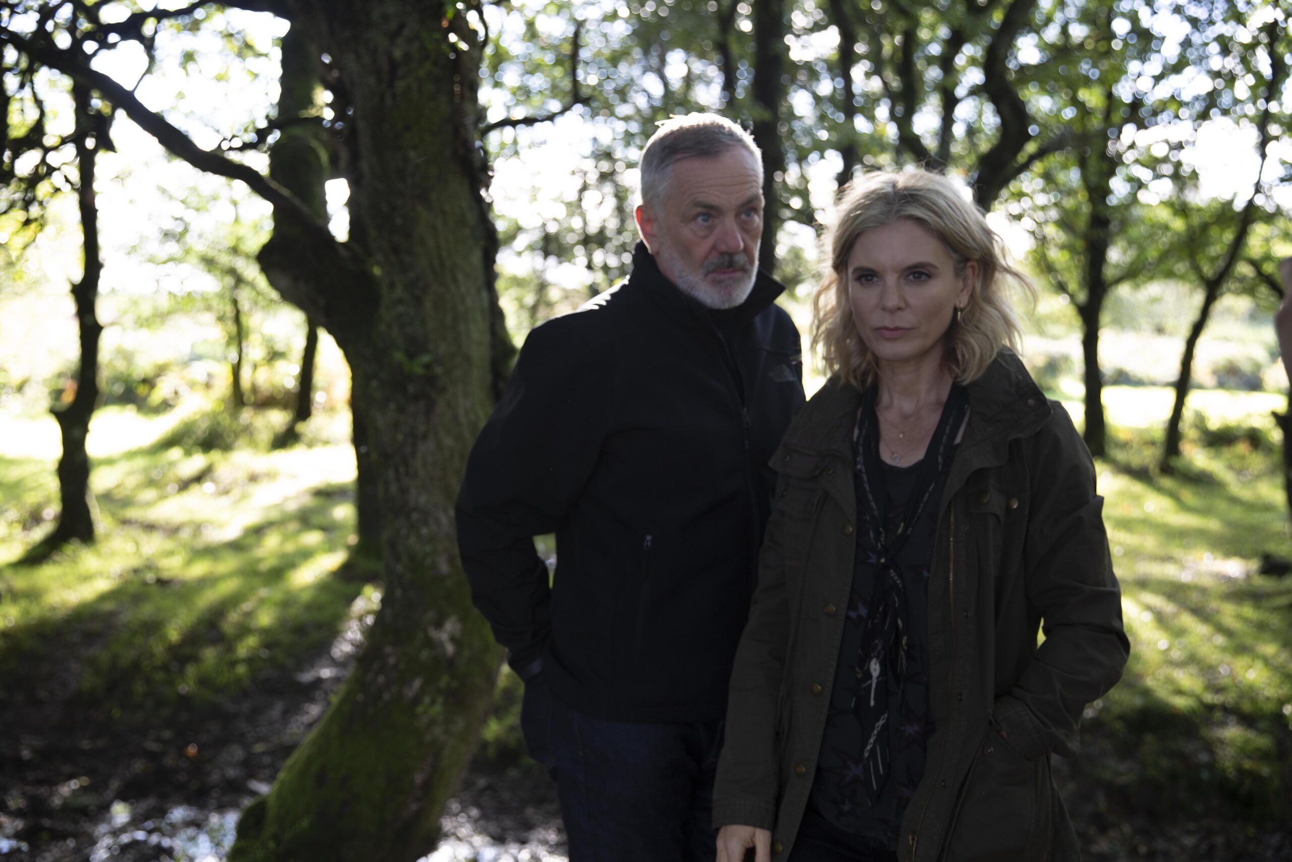 Emilia Fox and David Wilson stand in woods